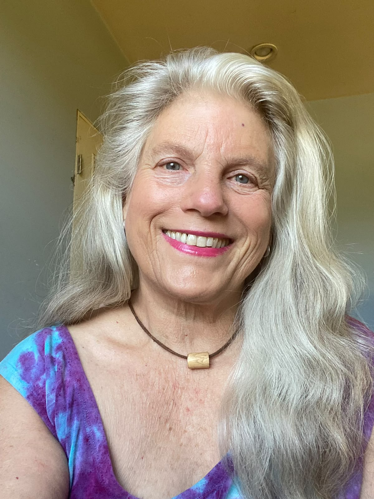 Catherine Whittall smiling among roses